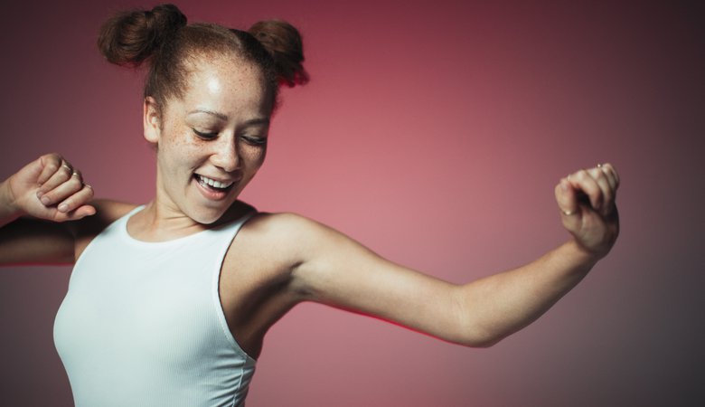 Carefree young woman dancing