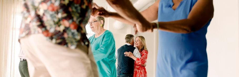 Senior couple enjoying while dancing in class