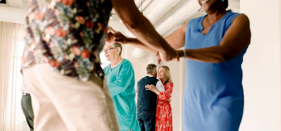 Senior couple enjoying while dancing in class